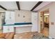 Bright kitchen with white cabinetry and wooden beam accents, offers ample counter space at 855 Pinewood W Ter, Palm Harbor, FL 34683