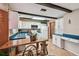 Kitchen featuring white cabinets, wooden accents, and a functional layout perfect for cooking and dining at 855 Pinewood W Ter, Palm Harbor, FL 34683