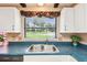 Kitchen with stainless steel sink and window looking out to a well maintained green lawn at 855 Pinewood W Ter, Palm Harbor, FL 34683