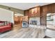 The living room has a decorative stone fireplace and opens to both the kitchen and the dining room at 855 Pinewood W Ter, Palm Harbor, FL 34683