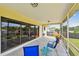 Comfortable screened patio with stylish seating and vibrant flowers, creating a serene outdoor space at 855 Pinewood W Ter, Palm Harbor, FL 34683