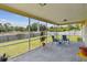 Inviting screened patio with views of the backyard, perfect for outdoor relaxation and entertaining at 855 Pinewood W Ter, Palm Harbor, FL 34683