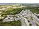 Birds eye view of a neighborhood surrounded by trees, with a few roads, houses, and green spaces visible at 9630 Carlsdale Dr, Riverview, FL 33578