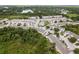 Wide aerial shot showing a community with tree lined streets near a lake, with blue sky overhead at 9630 Carlsdale Dr, Riverview, FL 33578