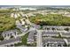 Aerial view of townhome community with lush greenery, nearby highway, and lake at 9630 Carlsdale Dr, Riverview, FL 33578