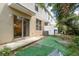 View of the backyard featuring a sliding door access and patio area with partial turf covering at 9630 Carlsdale Dr, Riverview, FL 33578