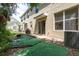 This home has a small backyard with mature foliage and air conditioning units at 9630 Carlsdale Dr, Riverview, FL 33578