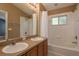 This bathroom features double sinks, a bathtub, and a shower at 9630 Carlsdale Dr, Riverview, FL 33578