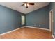 This bedroom has a ceiling fan, window with blinds, and wood-look flooring at 9630 Carlsdale Dr, Riverview, FL 33578