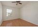 This bedroom has a ceiling fan, window with blinds, and wood-look flooring at 9630 Carlsdale Dr, Riverview, FL 33578