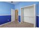 This bedroom has a walk-in closet with doors and a carpeted floor at 9630 Carlsdale Dr, Riverview, FL 33578
