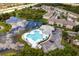 Aerial view of the heart-shaped community pool, lake, and clubhouse at 9630 Carlsdale Dr, Riverview, FL 33578