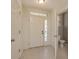 Welcoming entryway with a tiled floor, half-lite front door, and access to a convenient downstairs half-bathroom at 9630 Carlsdale Dr, Riverview, FL 33578