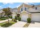 This inviting townhome offers convenient garages, charming landscaping, and curb appeal at 9630 Carlsdale Dr, Riverview, FL 33578