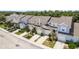 Aerial view of well-maintained townhomes featuring manicured lawns, driveways, and attached garages at 9630 Carlsdale Dr, Riverview, FL 33578