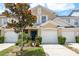 Charming townhome features a well-manicured lawn, attached garage, and a welcoming front entrance at 9630 Carlsdale Dr, Riverview, FL 33578