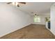 Spacious living room featuring plush carpet, a ceiling fan, natural light, and an open layout at 9630 Carlsdale Dr, Riverview, FL 33578