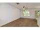 Comfortable living room with soft carpet, a ceiling fan, bright natural light, and an open floor plan at 9630 Carlsdale Dr, Riverview, FL 33578