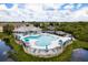 A high-angle view of a resort style pool and amenity center surrounded by lush green trees at 9630 Carlsdale Dr, Riverview, FL 33578