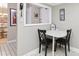 Bright breakfast area with white table and black chairs next to a pass-through to the kitchen at 1 Key Capri # 302E, Treasure Island, FL 33706