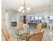 Dining area with a glass table, woven chairs and views into the living area at 1 Key Capri # 302E, Treasure Island, FL 33706