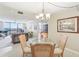 Dining area with glass table, chandelier and views into the living space at 1 Key Capri # 302E, Treasure Island, FL 33706