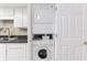 Convenient in-unit laundry closet features a stacked washer and dryer at 1 Key Capri # 302E, Treasure Island, FL 33706