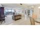 Bright living room with sliding glass doors and white tiled floors at 1 Key Capri # 302E, Treasure Island, FL 33706