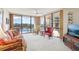 Bright and airy living room with floor-to-ceiling windows that look out to the community pool at 1 Key Capri # 302E, Treasure Island, FL 33706