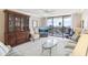 Comfortable living room featuring a sliding glass door and wood cabinet at 1 Key Capri # 302E, Treasure Island, FL 33706