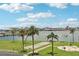 Scenic recreation area with shuffleboard, barbeque grills, palm trees, and waterfront views at 1 Key Capri # 302E, Treasure Island, FL 33706