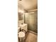 Bathroom featuring tile floors, vanity with sink, and shower with etched-glass sliding doors at 10502 Orange Blossom Ln, Seminole, FL 33772