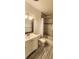 Bathroom features a vanity, a tiled shower, and a modern gray paint at 10502 Orange Blossom Ln, Seminole, FL 33772