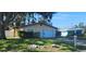 Charming single-story home with mature trees and a well-maintained lawn at 10502 Orange Blossom Ln, Seminole, FL 33772