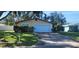 Home features a well-manicured lawn and a clean white garage door at 10502 Orange Blossom Ln, Seminole, FL 33772