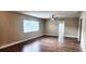 Spacious living room featuring new floors, ceiling fan and lots of light at 10502 Orange Blossom Ln, Seminole, FL 33772