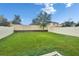 Lush backyard featuring vibrant green grass, a sturdy fence, and ample space for outdoor activities and landscaping at 11019 Leland Groves Dr, Riverview, FL 33579