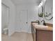 Double sink bathroom vanity with wood cabinets and modern lighting at 11019 Leland Groves Dr, Riverview, FL 33579