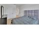 Well-lit bedroom with a plush gray headboard, matching gray comforter, and a dark dresser that offers storage and style at 11019 Leland Groves Dr, Riverview, FL 33579