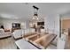 Open-concept dining area with wood table, neutral chairs, and view of the open living spaces at 11019 Leland Groves Dr, Riverview, FL 33579