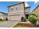 Charming two-story home with a well-maintained lawn and colorful landscaping at 11019 Leland Groves Dr, Riverview, FL 33579