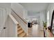 Bright foyer with hardwood floors and staircase that flows into the spacious living room at 11019 Leland Groves Dr, Riverview, FL 33579