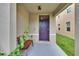 Inviting covered front porch with a cozy bench and a freshly painted front door at 11019 Leland Groves Dr, Riverview, FL 33579