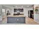 Modern kitchen with a large island and stylish cabinets with granite countertops at 11019 Leland Groves Dr, Riverview, FL 33579