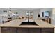 Kitchen island with a black sink, dishwasher, and open layout to living room at 11019 Leland Groves Dr, Riverview, FL 33579