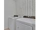 Well-equipped laundry room featuring modern washer and dryer at 11019 Leland Groves Dr, Riverview, FL 33579