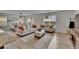 Inviting living room with lots of natural light, neutral decor, and an open dining area at 11019 Leland Groves Dr, Riverview, FL 33579