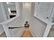 Carpeted staircase with white railings leading to a lower level, complemented by neutral walls and natural light at 11019 Leland Groves Dr, Riverview, FL 33579