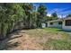 Spacious backyard with a shed, landscaping, and partial grass, ready for customization and outdoor enjoyment at 112 Peterson Ln, Palm Harbor, FL 34683