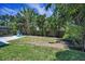 Expansive backyard with lush tropical landscaping and ample space for outdoor activities and relaxation at 112 Peterson Ln, Palm Harbor, FL 34683